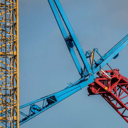 Yellow, blue and red metal constructions attached to each other during daytimeの写真素材