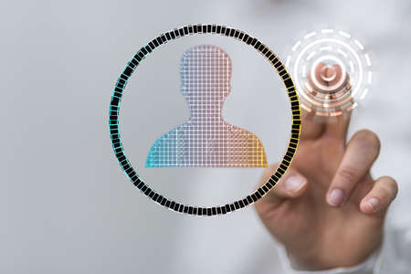 A person touching a virtual projection of a composition of a human face - frame of mind conceptの写真素材