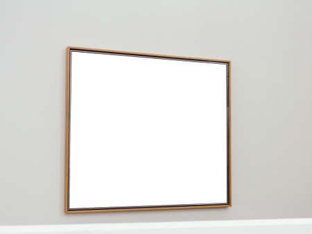 A white rectangular surface with brown frames attached to a wall of light grayの写真素材