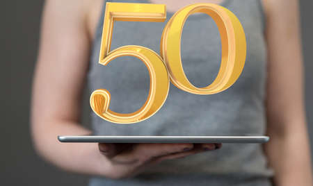 A person presenting a virtual projection of the fiftieth-anniversary numberの写真素材