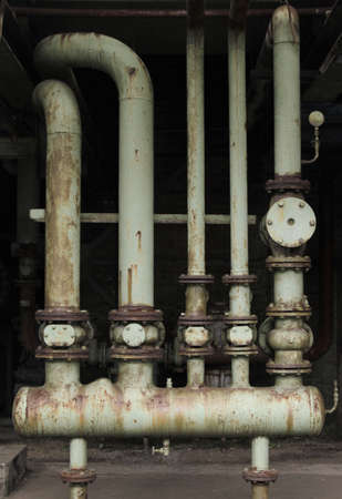 A vertical shot of an old factory rusted tubesの写真素材