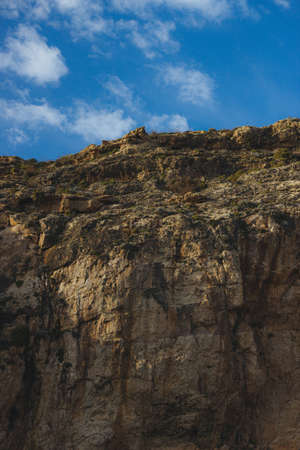A beautiful shot of a cliff with a clear sky in the backgroundの写真素材