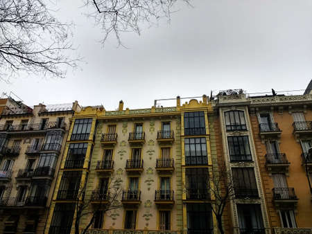 A low angle shot of a building in Spain under a cloudy sky