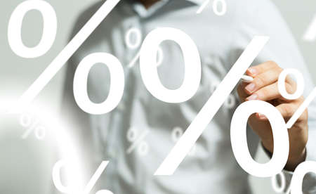 A businessman presenting a virtual projection of percentage icons at a business meeting