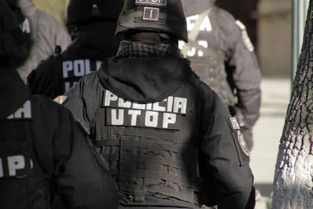 A closeup shot of men in black police uniforms during daytime