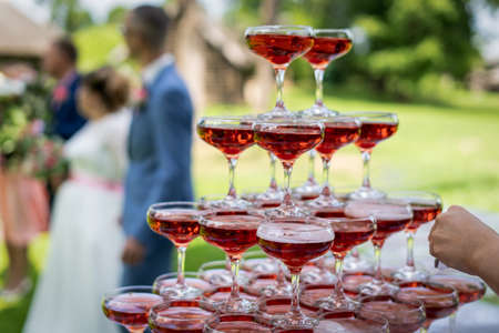 A closeup shot of glasses of red cocktail stacked on top of each otherの写真素材