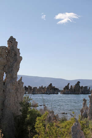 Several cliffs surrounding and sticking out of the ocean on the beachの写真素材