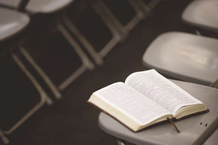 An open book in a grey chair in the conference roomの写真素材