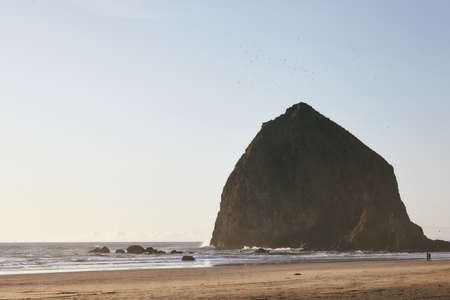 A mesmerizing scenery of sunset at Haystack Rock at the Pacific Ocean, Oregonの写真素材