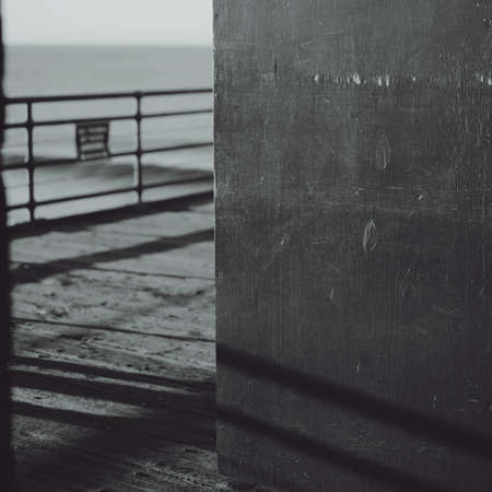 A grey-scale shot of a wall with stitches near the beachの写真素材