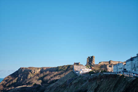 SCARBOROUGH, UNITED KINGDOM - Jan 18, 2020: Zoomed out horizontal shot of the castle ruins in Scarborough north yorkshire on a bright cold sunny cloud free skyのeditorial素材