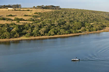 ST FRANCIS BAY, SOUTH AFRICA - Dec 15, 2019: A family cruising on a speedboat on the Krom river near St Francis bay. This is a popular vacation area in the Eastern Cape Province of South Africa.のeditorial素材