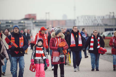 MUNICH, GERMANY - Jan 25, 2020: Crowed of fans walking to Allianz Arena during match day. Famous german soccer club FC Bayern Munich is playing a match. Fans are happy and exited.のeditorial素材