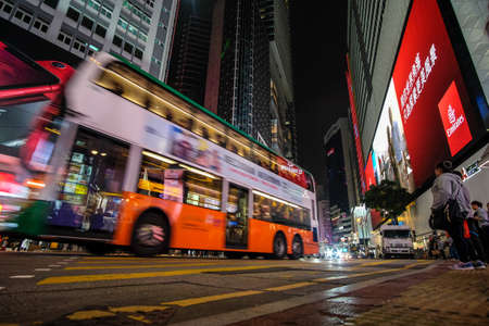 HONG KONG, BOTSWANA - Mar 04, 2019: Double decker buses drive on the road of Causeway Bay on a rainy evening.のeditorial素材