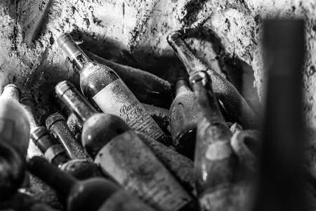 ALBA, ITALY - Jul 28, 2016: old bottles of wine in a cellar in the Langhe are, Piedmont, Italyのeditorial素材