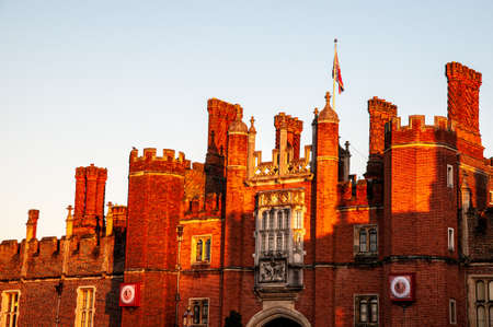 Bright red brick front of a palace in orange dusk light