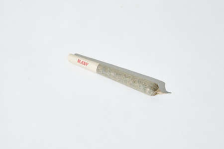 LOS ANGELES, UNITED STATES - Jan 13, 2017: Hemp/Marijuana joint in RAW pre-rolled cone paper on...