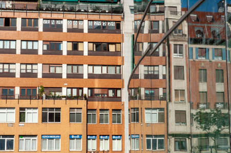 BILBAO, SPAIN - Oct 26, 2009: Coloured building reflected on the wall of Another building in Plaza...