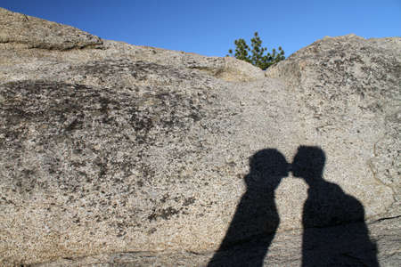 A wide angle shot of the shadow of a kissing coupleの写真素材