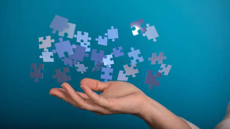A person presenting a virtual projection of puzzles - business solution concept