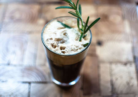 A high angle view of a glass of Irish coffee under the lights with a blurry backgroundの写真素材