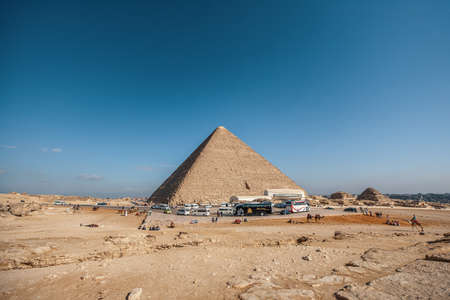 A wide angle shot of an Egyptian pyramid under a clear blue skyの写真素材