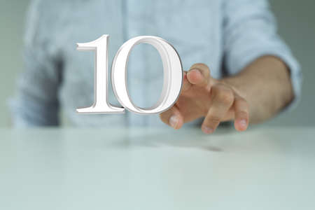 A person presenting a visual projection of digital number ten at a meetingの写真素材