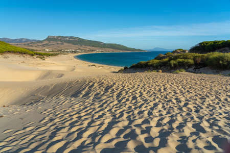 A beautiful shot of estrecho natural park of bolonia beach in spain during daytime with a cloudy blue sky in the backgroundの写真素材