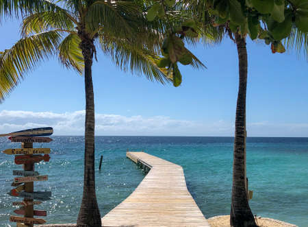 A beautiful shot of a ramp in the beach with a breathtaking view of the blue ocean during daytimeの写真素材