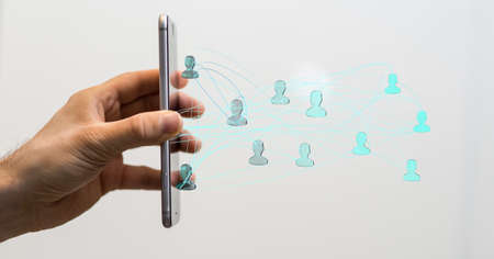 A businessman presenting a virtual projection of a teamwork network - concept of teamwork