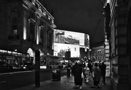 LONDON, UNITED KINGDOM - Apr 11, 2019: A greyscale shot of people walking in the historic city of London during the evening timeのeditorial素材