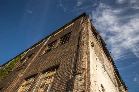 A low angle shot of an old stone building under the sky with a few cloudsのeditorial素材