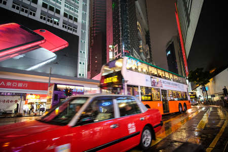 HONG KONG, BOTSWANA - Mar 04, 2019: Double decker buses drive on the road of Causeway Bay on a rainy evening.のeditorial素材