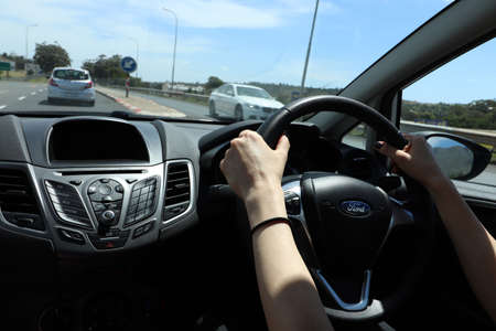 CAPE TOWN, SOUTH AFRICA - Dec 06, 2019: A women driving a Ford Fiesta on the N2 highway. This is a...