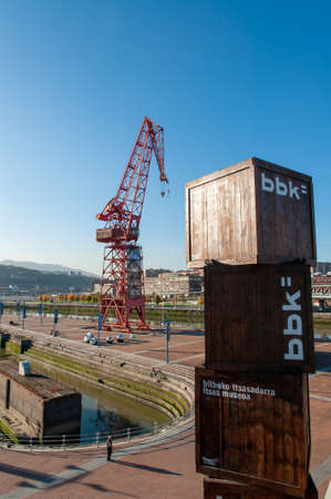An outside view of the Maritine Museum of Bilbao, Spain with a red crane in the backgroundのeditorial素材