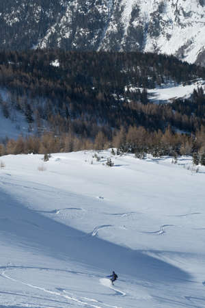 CHAMONIX, FRANCE - Feb 20, 2018: A vertical shot of a snowboarding man in snowy mountains