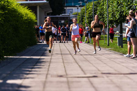 SCHMALKALDEN, GERMANY - Jun 25, 2019: Young student sprinting at university sport event during summerのeditorial素材