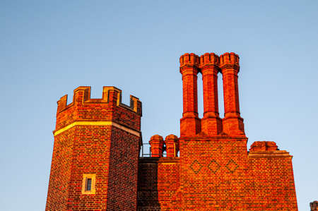 Historic tall red chimnies in orange lightのeditorial素材