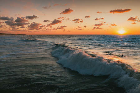 The beautiful ocean waves under the colorful sky at sunset captured in Domburg, Netherlandsのeditorial素材