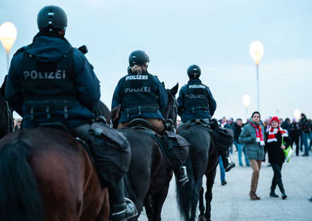 MUNICH, GERMANY - Jan 25, 2020: Mounted police at german soccer game of famous football club FC Bayern Munich. Police is keeping game safe while fans have fun.のeditorial素材