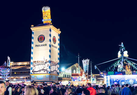 MUNICH, GERMANY - Sep 29, 2019: People and attraction at munich bavaria Oktoberfest world famous folk festival illuminated people during night dark lightのeditorial素材