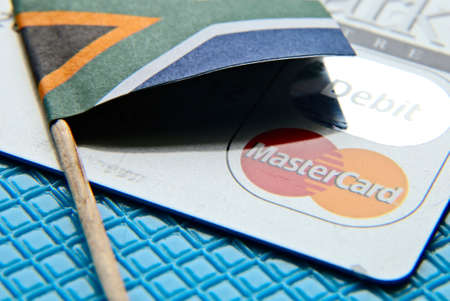 PORT ELIZABETH, SOUTH AFRICA - Apr 04, 2019: South Africa credit rating concept image consisting of a flag and mastercard.のeditorial素材