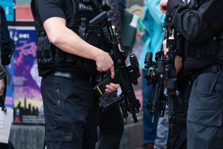 LEEDS, UNITED KINGDOM - May 05, 2019: Horizontal shot of armed police patrolling tour de yorkshire crowd to keep everyone safeのeditorial素材