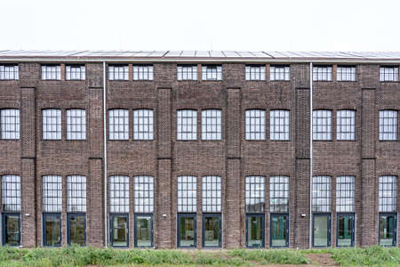 A great shot of a warehouse with glass windows and brick exterior wallsのeditorial素材