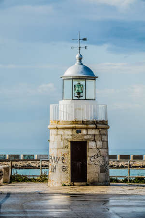 A closeup shot of a tower in front of the water under a cloudy skyのeditorial素材