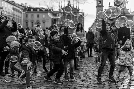 TURIN, ITALY - Jan 20, 2020: happy kids playing with soap bubblesのeditorial素材