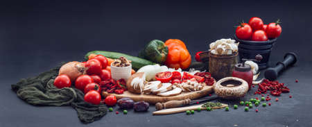 Delicious fresh vegetables placed in a black surfaceの写真素材