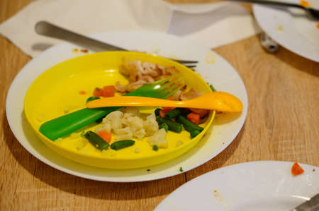 Several plates next to each other containing remains of food