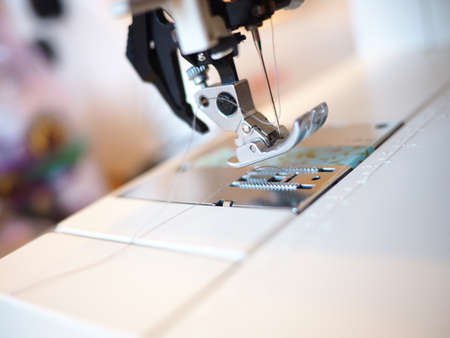 A closeup shot of a tailor's electronic machine sewing clothes