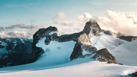 A mountain top peaking through a glacier in Greenland